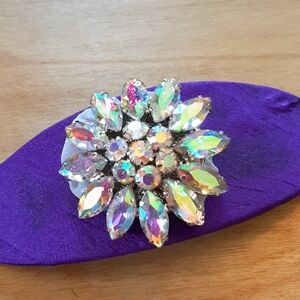 Artist made hair barrette with purple silk and large rhinestone pin.
